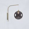 Lámparas Markslöjd Lighting Dione wall light with plug, brass/smoke grey